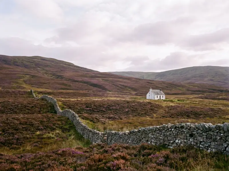Sweeping rural Highland landscape with one small white-rendered property